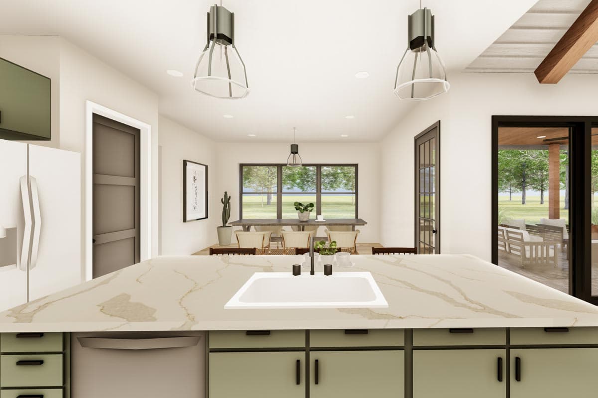 Open-concept kitchen with island sink, dining area, and outdoor patio access. Modern pendant lights and large windows.