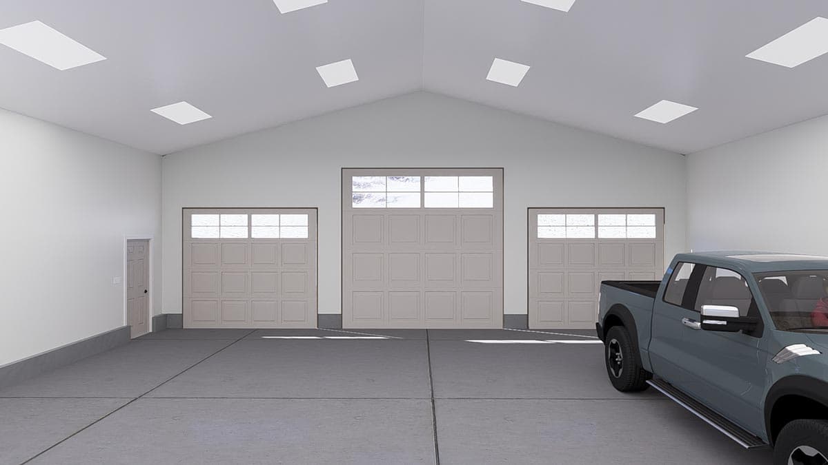 Interior view of a garage with three garage doors, one large and two smaller, and a side door.