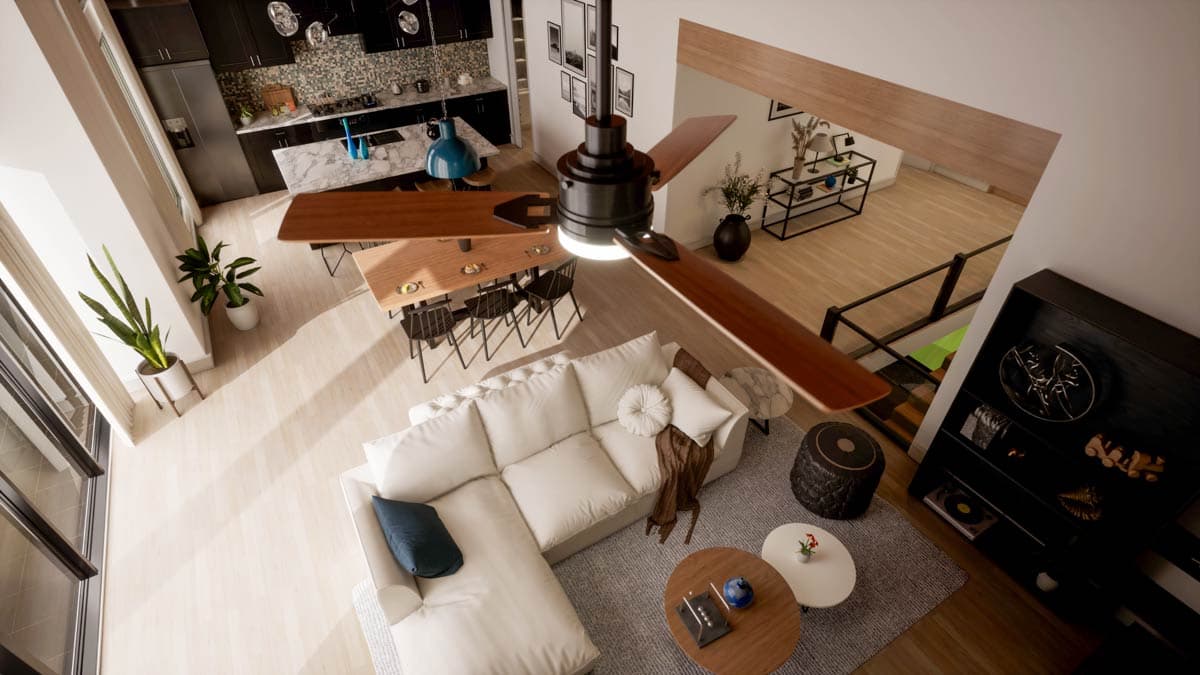 An overhead shot of a modern, open-plan living space. It includes a kitchen, dining area, a large white sectional, and a ceiling fan.