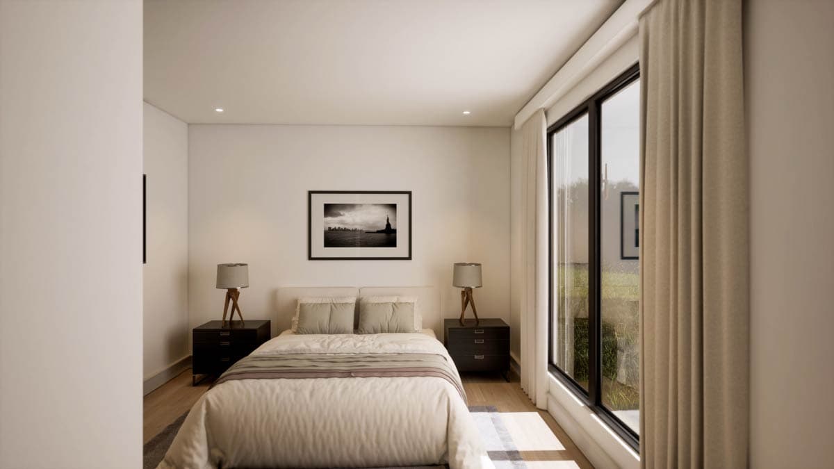 Modern bedroom with a bed, nightstands, and a framed black and white photograph above the bed. Large windows offer a view and natural light.