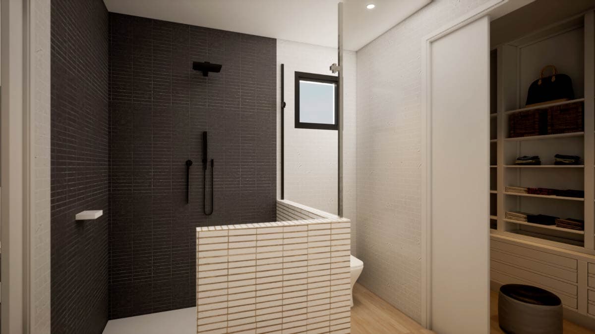 Modern bathroom with a tiled shower and a partially visible walk-in closet. The shower has dark tiles and black fixtures, and a glass partition.