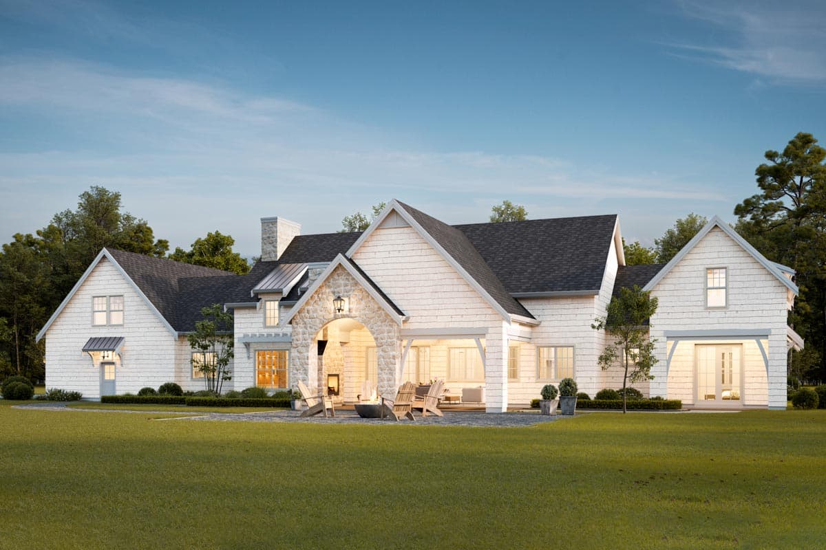 Modern Farmhouse house plan exterior with stone entry arch, multiple gables, and shingle siding.