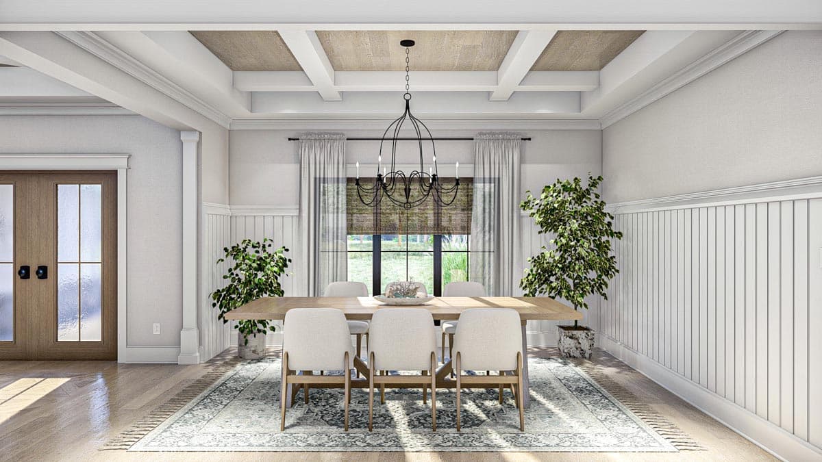 Dining room with coffered ceiling, wainscoting, large table with chairs, and double doors.