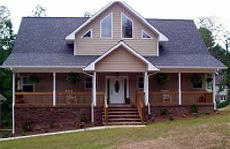 House plan exterior: Two-story home with wrap-around porch, dormer windows, and prominent gable.