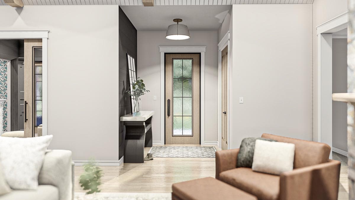 Interior view showing a wood-paneled front door with a glass inset, a console table, and seating.