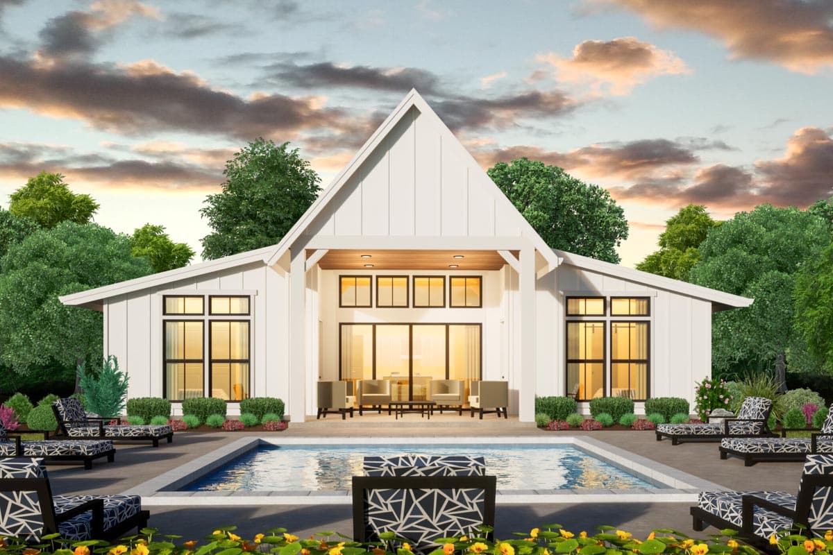 Modern farmhouse house plan exterior with large gables, a covered patio, and extensive windows, overlooking a swimming pool.