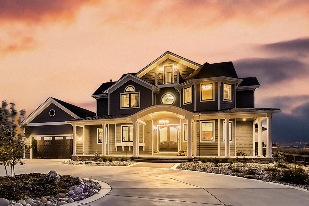 House plan exterior. Two-story home with front porch, multiple gables, dormers, and an attached garage. Features a curved driveway and landscape.