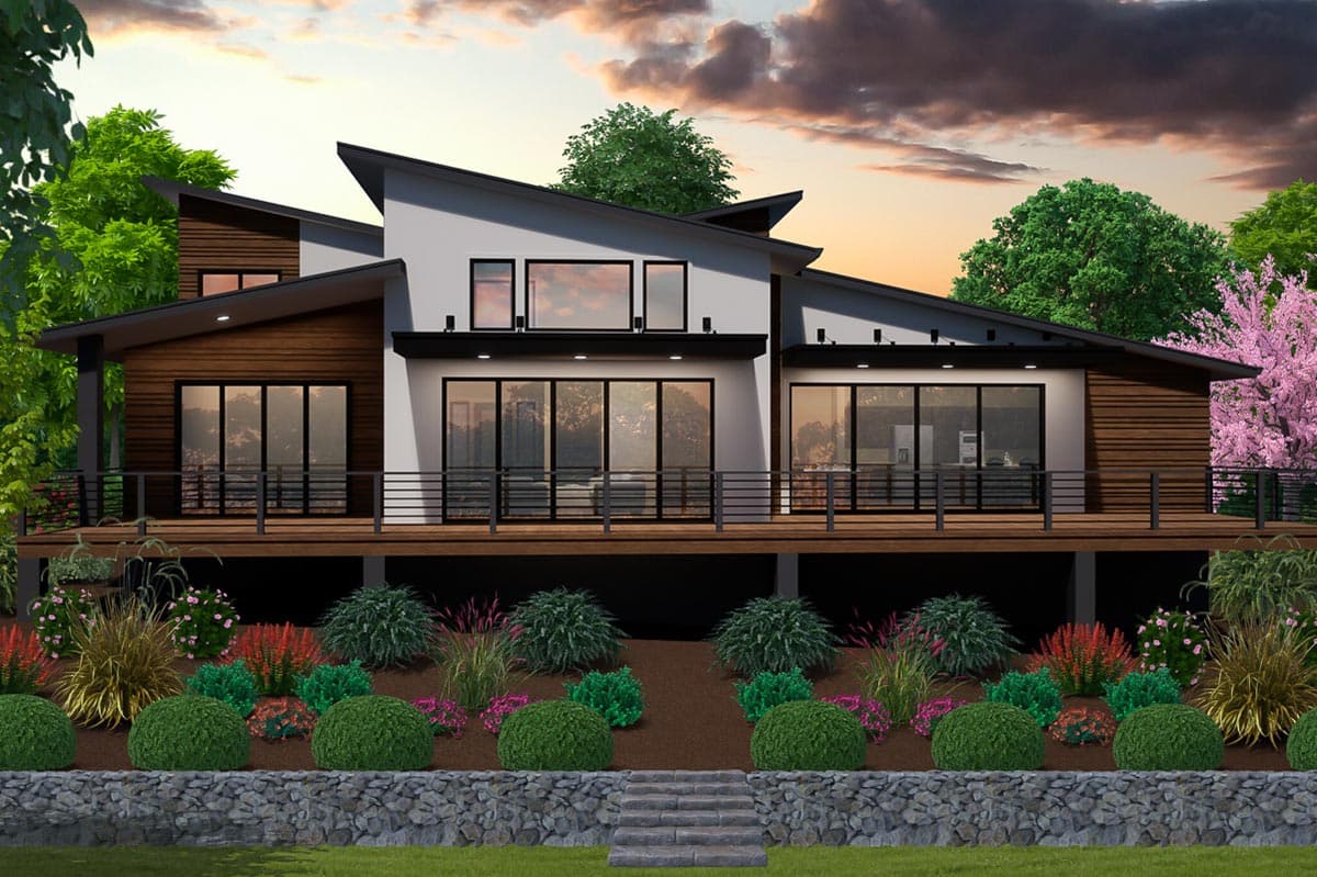 Modern house plan exterior with angled rooflines, wood siding, a wraparound deck, and expansive glass windows.