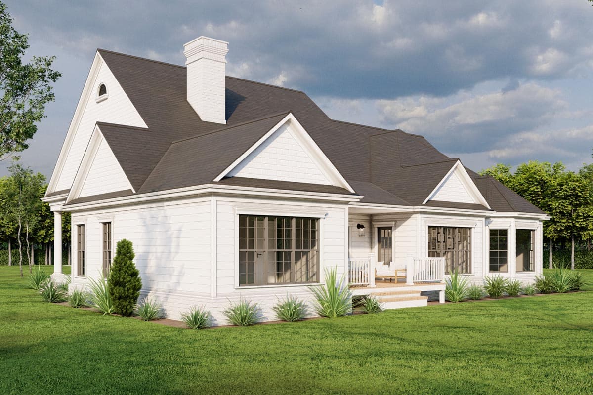 House plan exterior: White siding, gabled roof, prominent chimney, porch, and many windows.