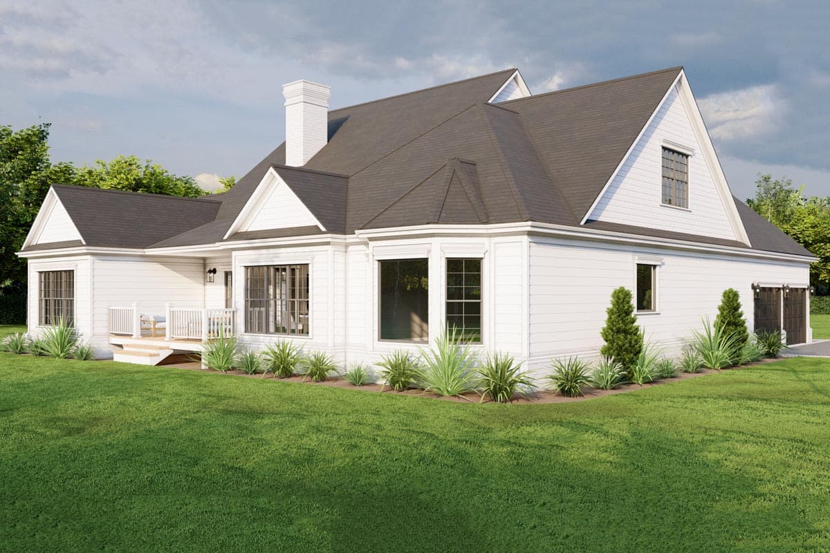 House plan exterior: white siding, gabled dormer, bay window, chimney, deck, and dual garage doors.
