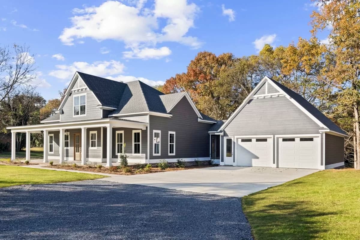 Modern Farmhouse style house plan exterior with wraparound porch, gables, and a two-car garage.