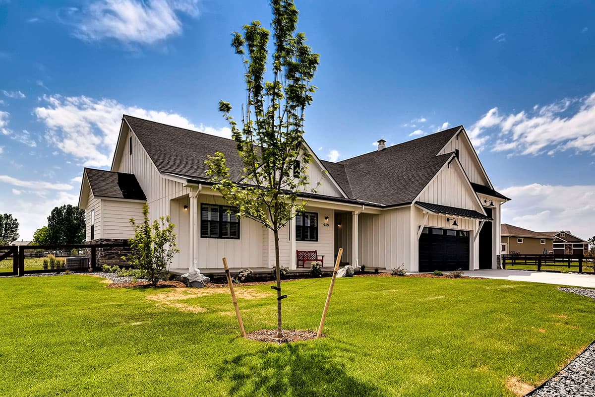 Modern Farmhouse style house plan exterior with board and batten siding, gables, covered porch, and attached garage.
