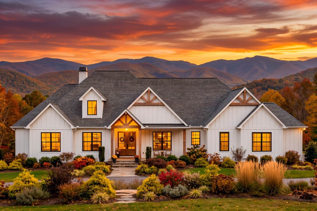 Modern Farmhouse plan exterior with board-and-batten siding, prominent gables, dormer window, and covered entryway.