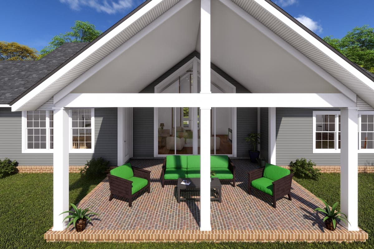 House plan exterior with covered porch, gabled roof, and gray siding. Includes seating on brick patio.