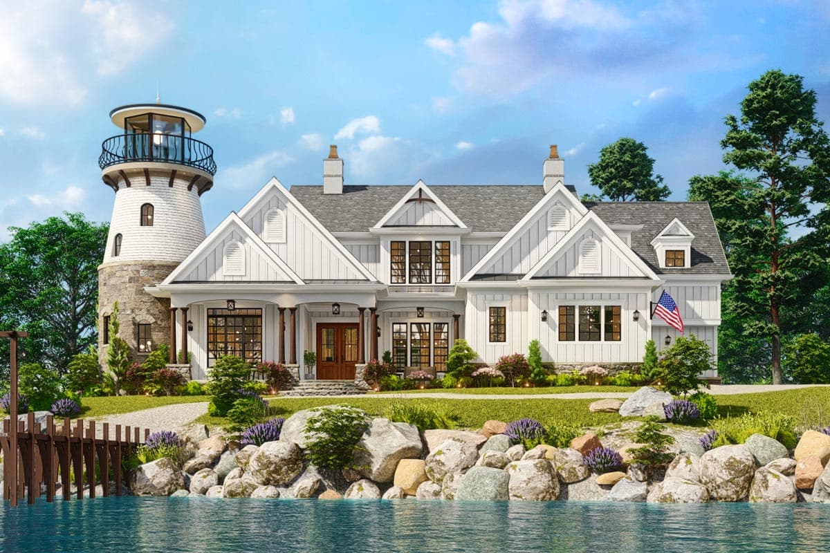 House plan exterior with lighthouse feature. Two-story with gables, a porch, and a diverse roofline. Includes an American flag.