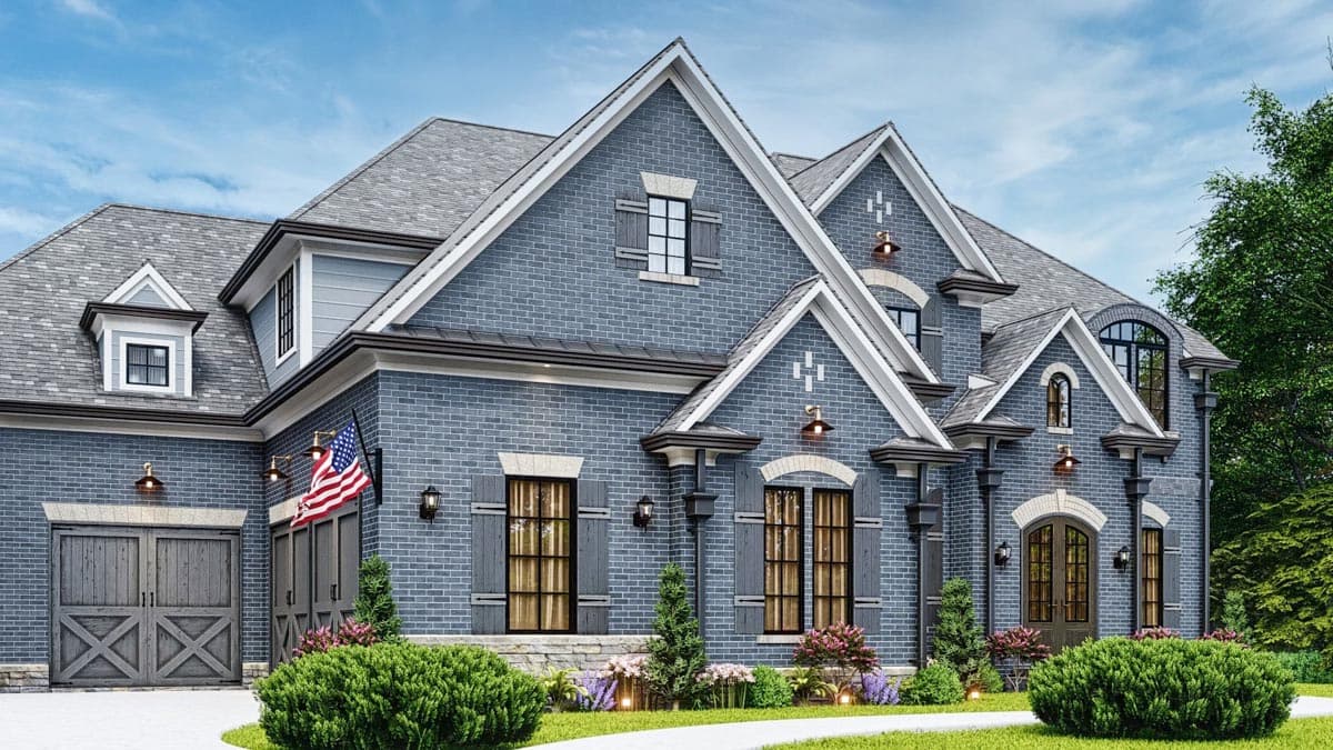 House plan exterior: Two-story blue brick home with multiple gables, dormers, stone accents, and a detached garage.