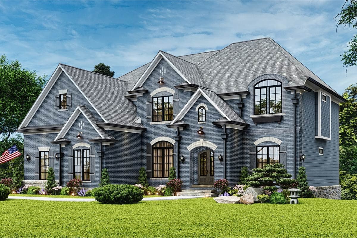House plan exterior: Two-story home with brick facade, multiple gables, arched windows, and prominent dormers.