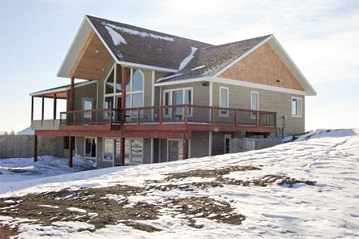 House plan exterior, two stories, gabled roof with dormers, large deck, and a covered porch.