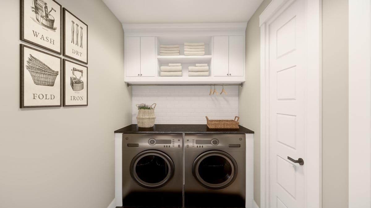 Laundry room with stacked washers and dryers, white subway tile backsplash, upper cabinets, and wash/dry/fold/iron art.