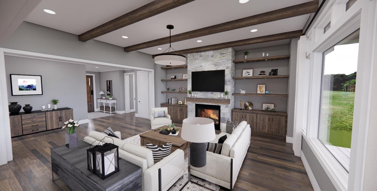 Living room with stone fireplace, built-in shelving, beamed ceiling, and open access to hallway.