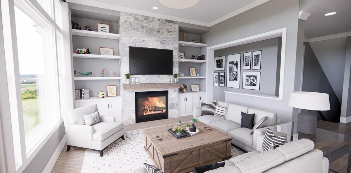 Living room with stone fireplace, built-in shelves, large windows, and sofas.