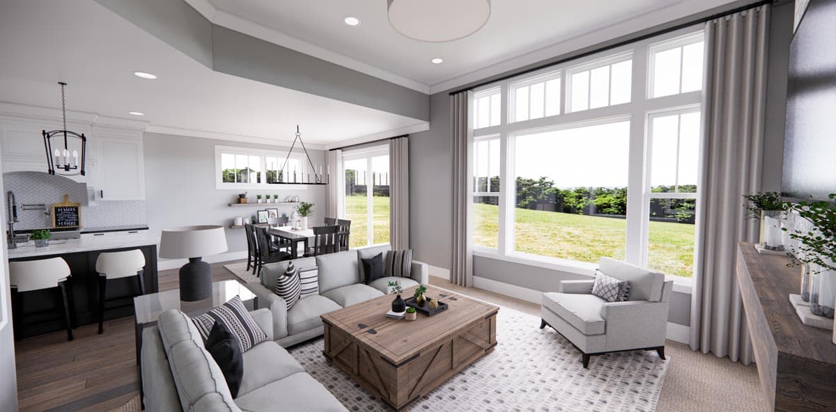Open-concept living area with kitchen island, dining area, and seating around a coffee table. Large windows provide exterior views.
