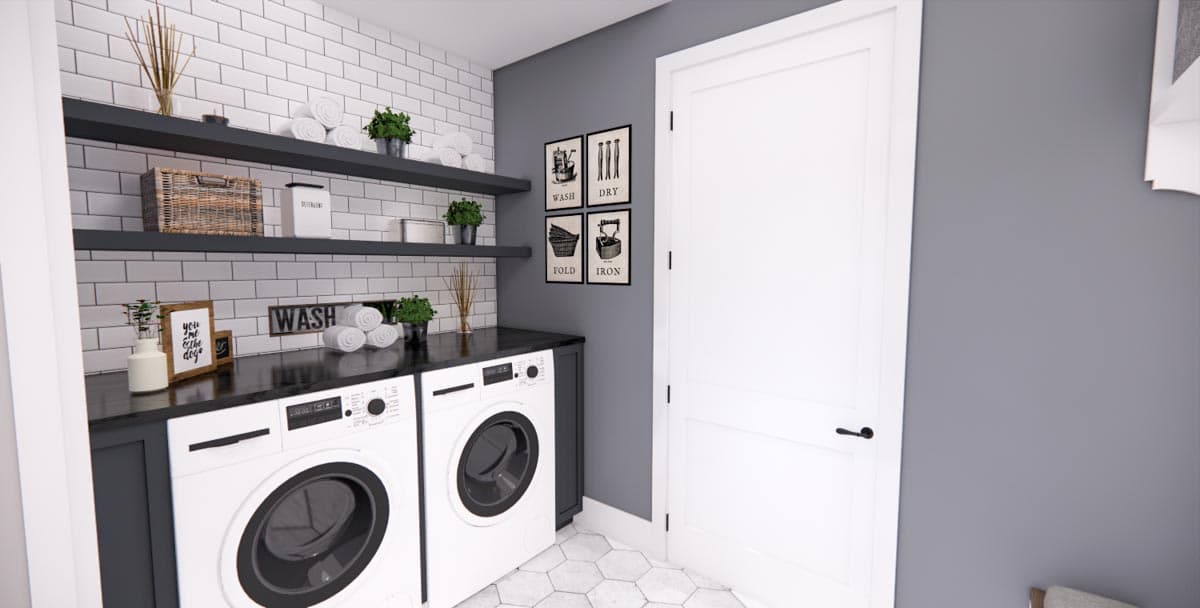 Laundry room with white subway tile backsplash, dark countertops, two front-load washers, and open shelving.