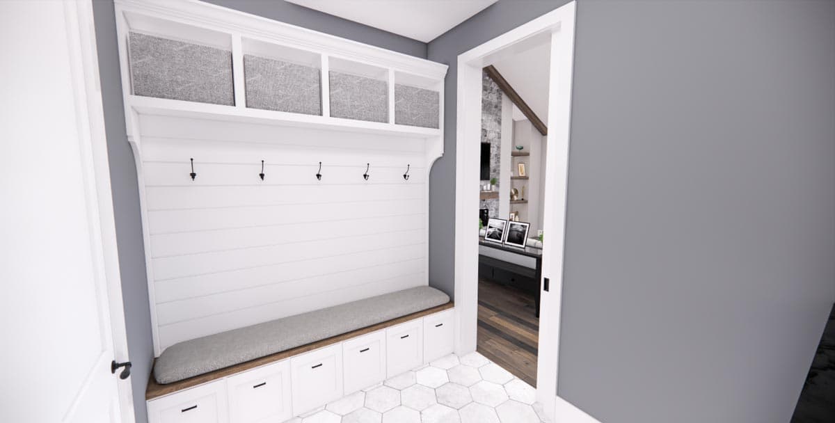 Mudroom with shiplap wall, built-in bench, cubbies, and storage drawers with hexagonal tile floor.