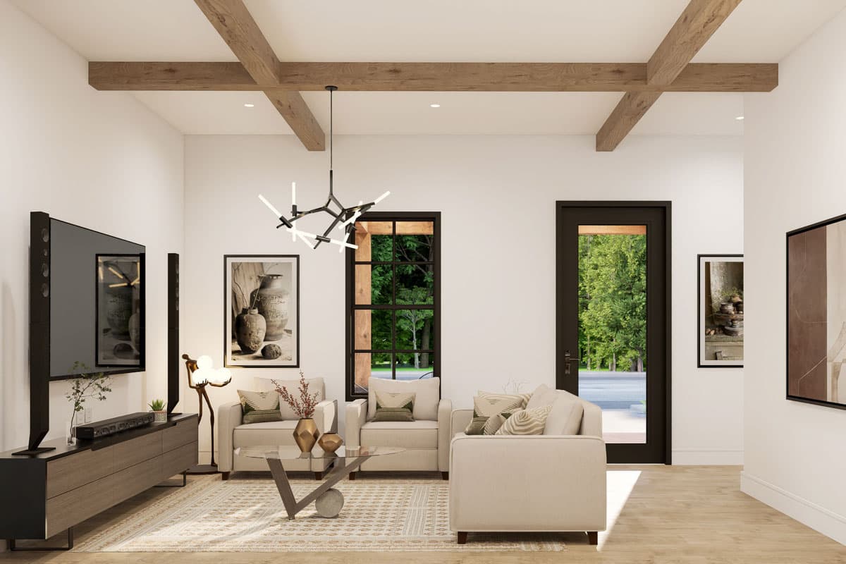 Living room with wood beam ceiling, large windows, and contemporary furnishings, including sofa and armchairs.
