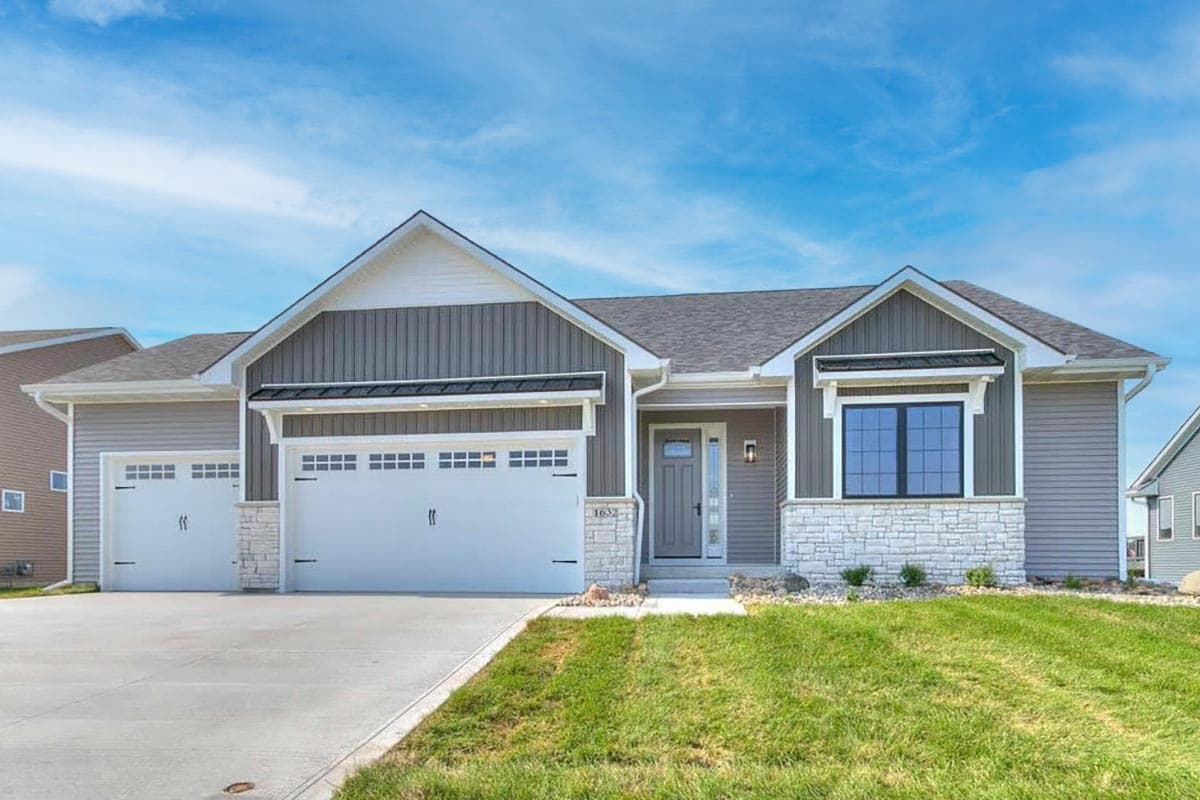 House plan exterior of a single-story Modern Farmhouse with a gable roof, two-car garage, and stone accents.