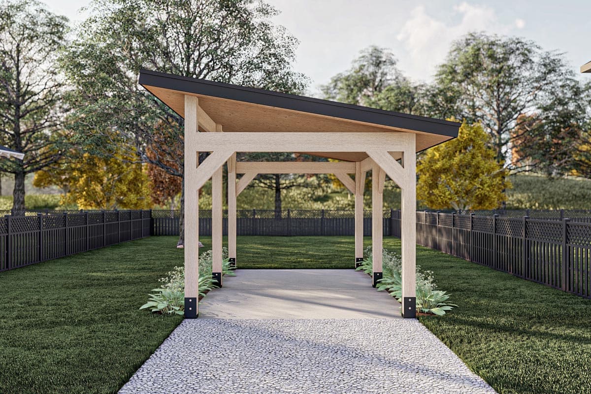 Modern open-air timber frame pavilion with a shed roof, concrete floor, and gravel pathway.