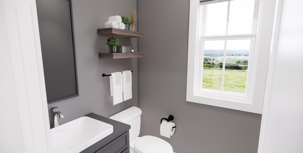Modern bathroom interior with vanity, toilet, two floating shelves, towel rack, and large window with a scenic view.
