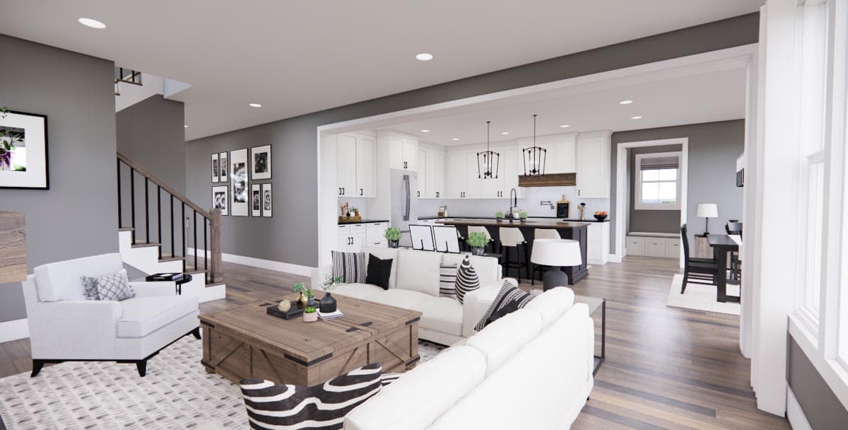 Open-concept living area rendering showing a white sectional, wood coffee table, stairs, and kitchen with island and white cabinets.