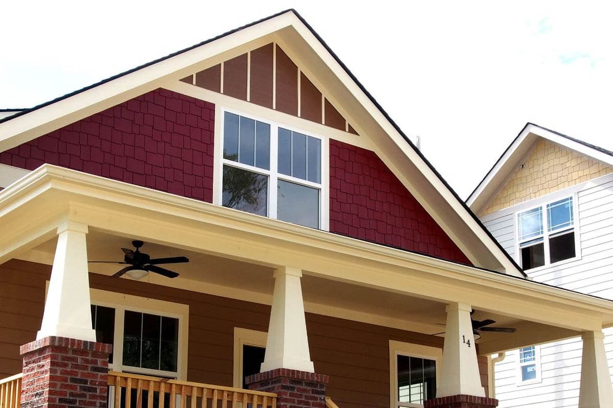 House plan exterior featuring a deep front porch with square columns, gable vents, and shingle siding.