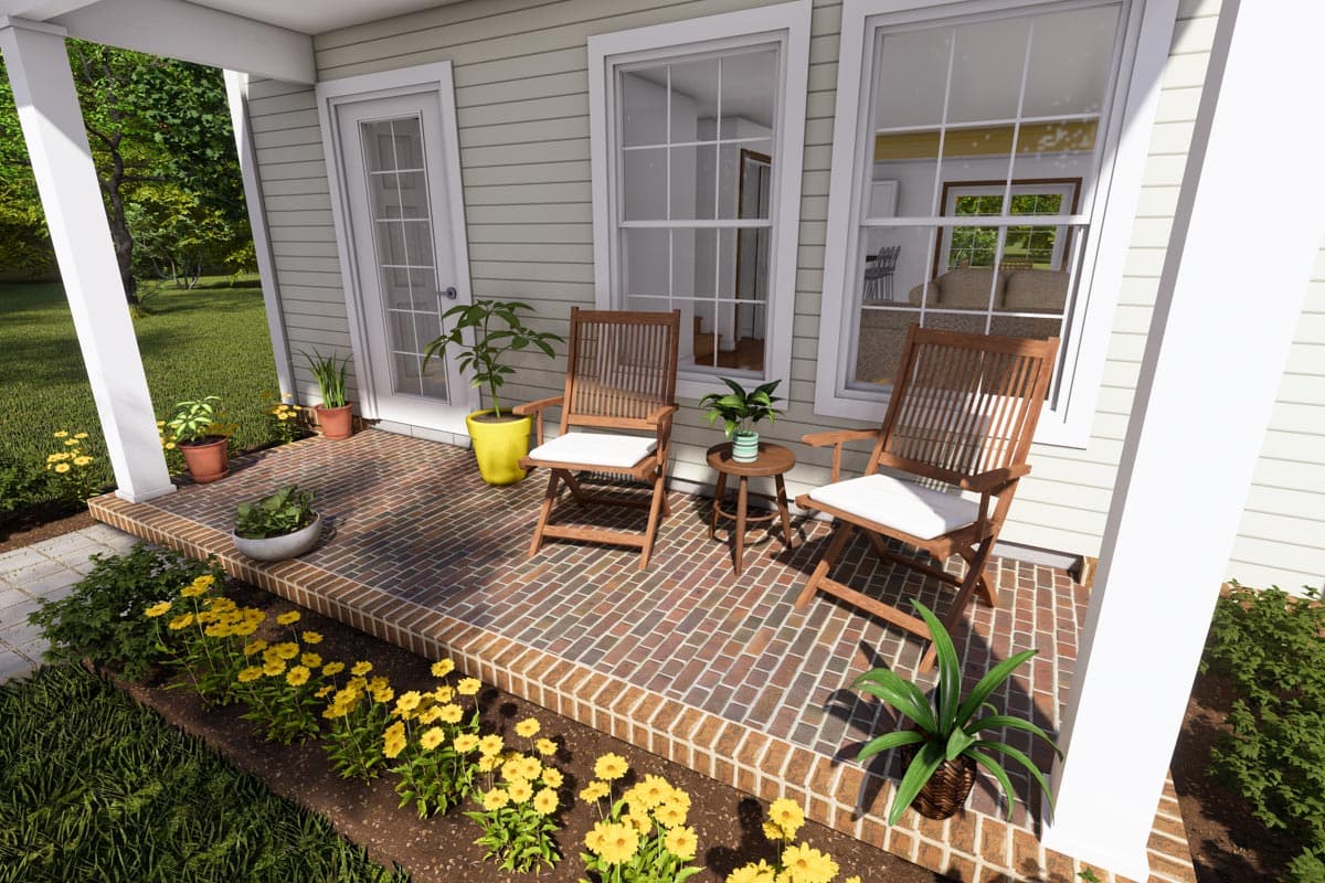 House plan exterior showing a covered porch with brick flooring, two chairs, and double-hung windows.