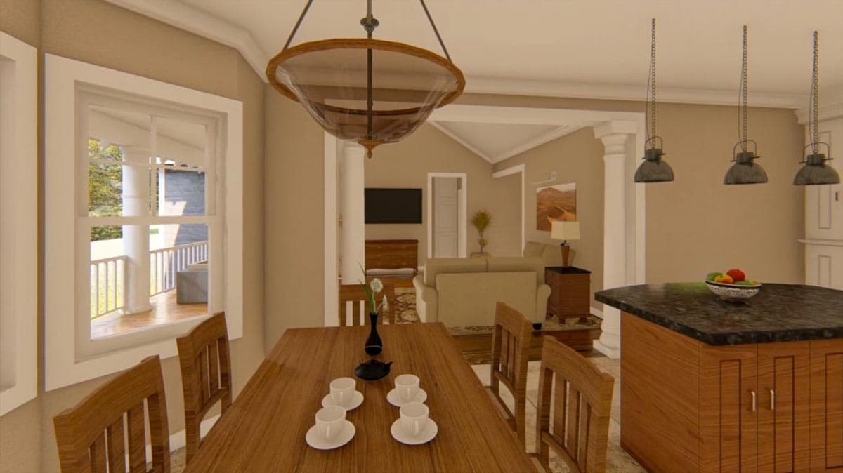 Open-concept dining and kitchen area with island, pendant lights, and view to porch.