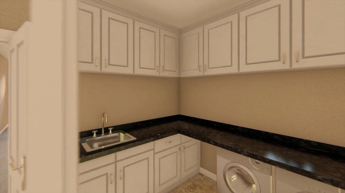 Laundry room with white cabinets, granite countertop, sink, and washing machine.