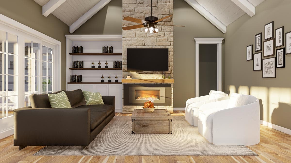 Interior view of living room with vaulted beamed ceiling, stone fireplace, built-in shelving, and french doors.