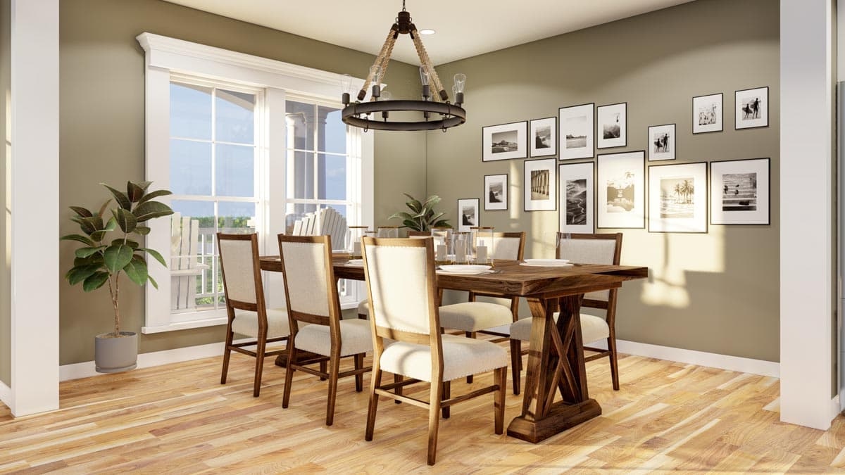 Dining room with wooden table, upholstered chairs, large window, and gallery wall of black and white photographs.