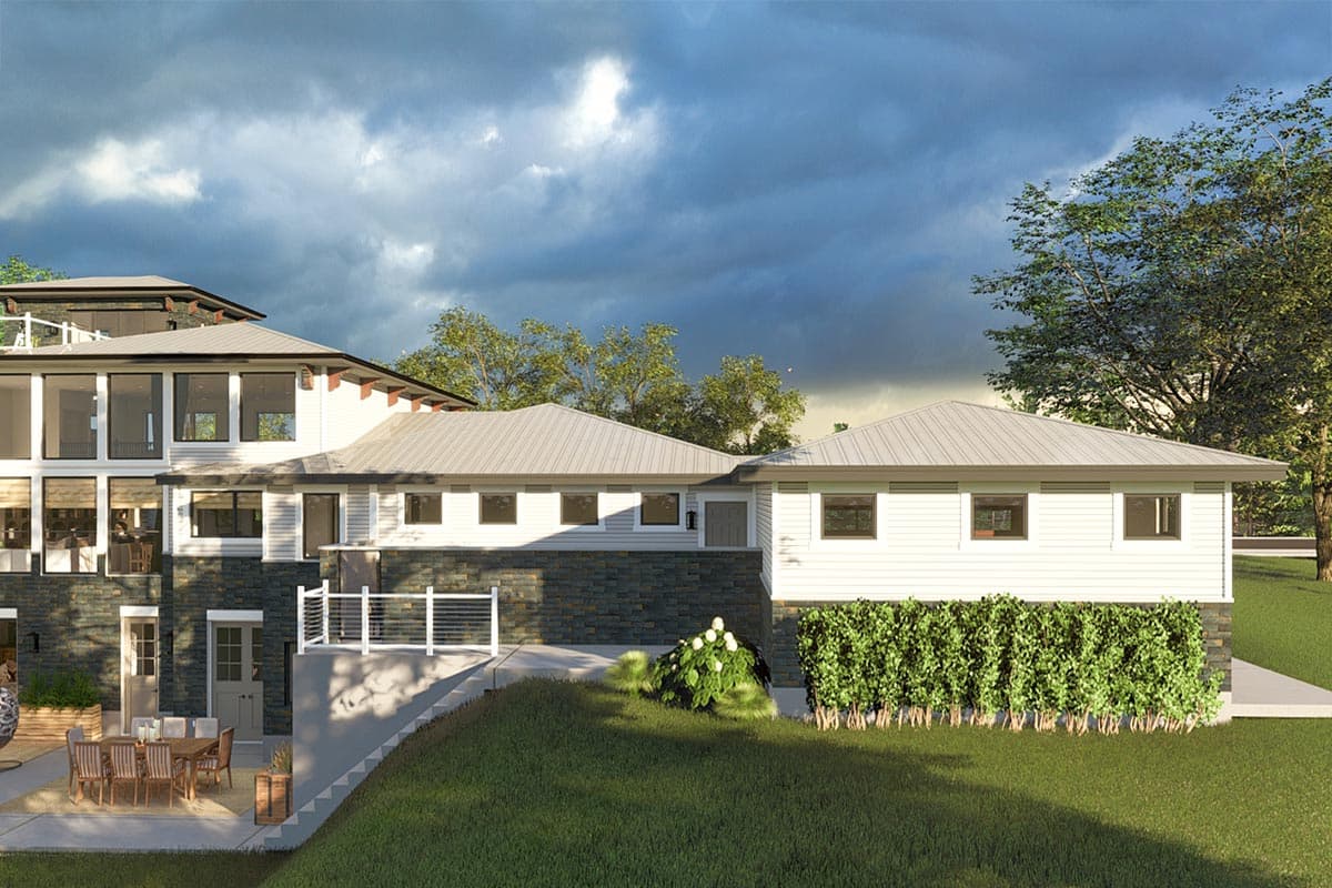 House plan exterior with multiple gables, horizontal siding, stone base, and outdoor patio.