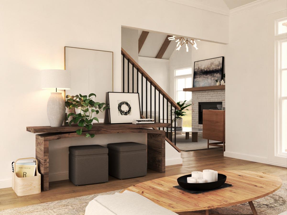 Interior view of open-concept living space with staircase, fireplace, and wood beams.