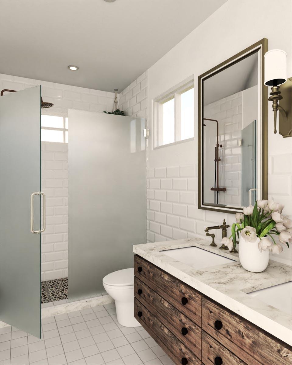 Bathroom with dual sinks, marble countertop, wooden vanity, frosted glass shower enclosure, subway tile walls, and decorative floor tile.