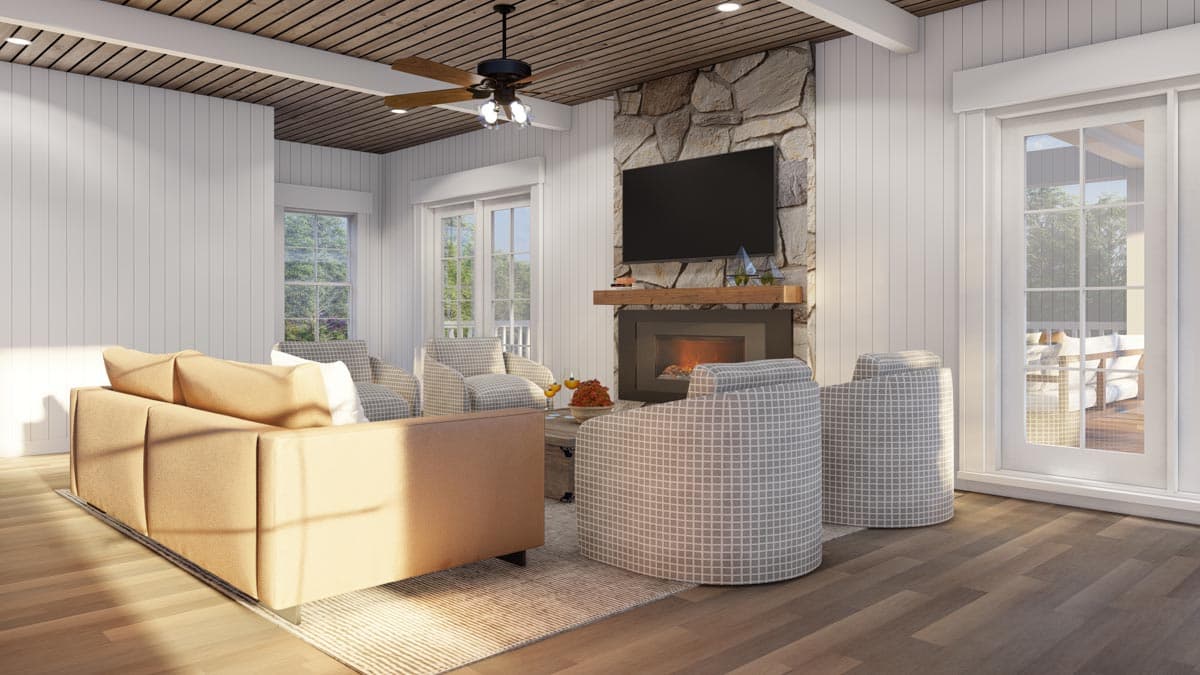 Living room with stone fireplace, sectional sofa, chairs, and wood plank ceiling.