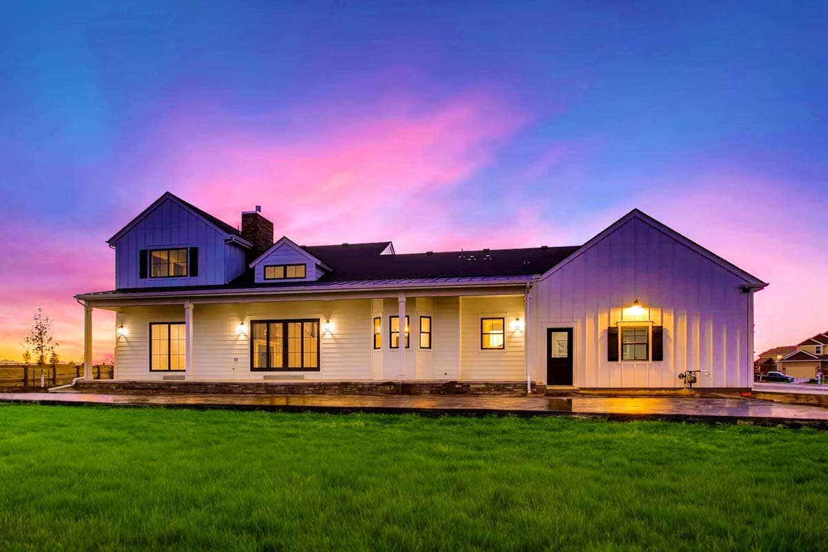 Modern Farmhouse house plan exterior with a wraparound porch, board-and-batten siding, and multiple gables.