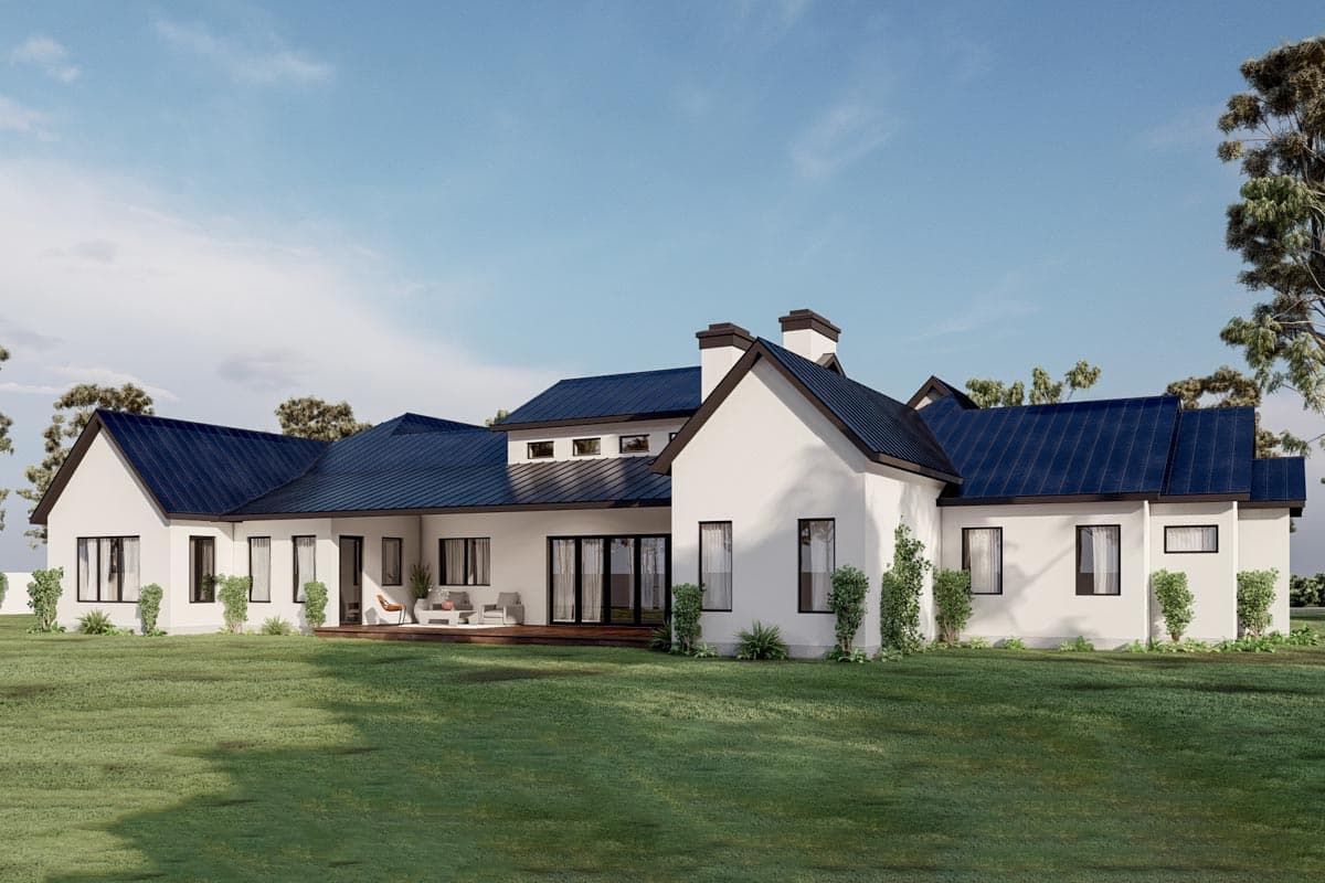 Modern farmhouse house plan exterior with a low-pitched gable roof, white stucco walls, and dark metal roofing.