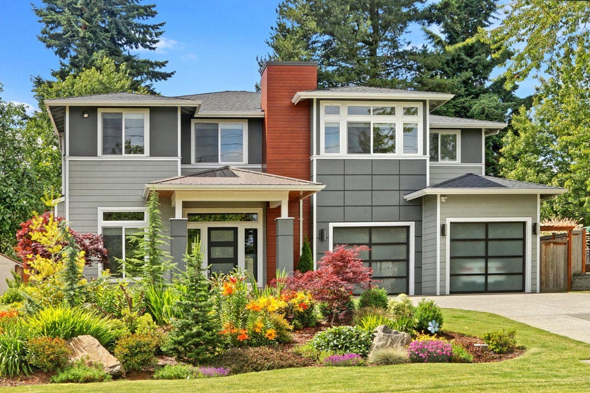 Modern two-story house plan with mixed siding, a covered entry, and a three-car garage with glass doors.