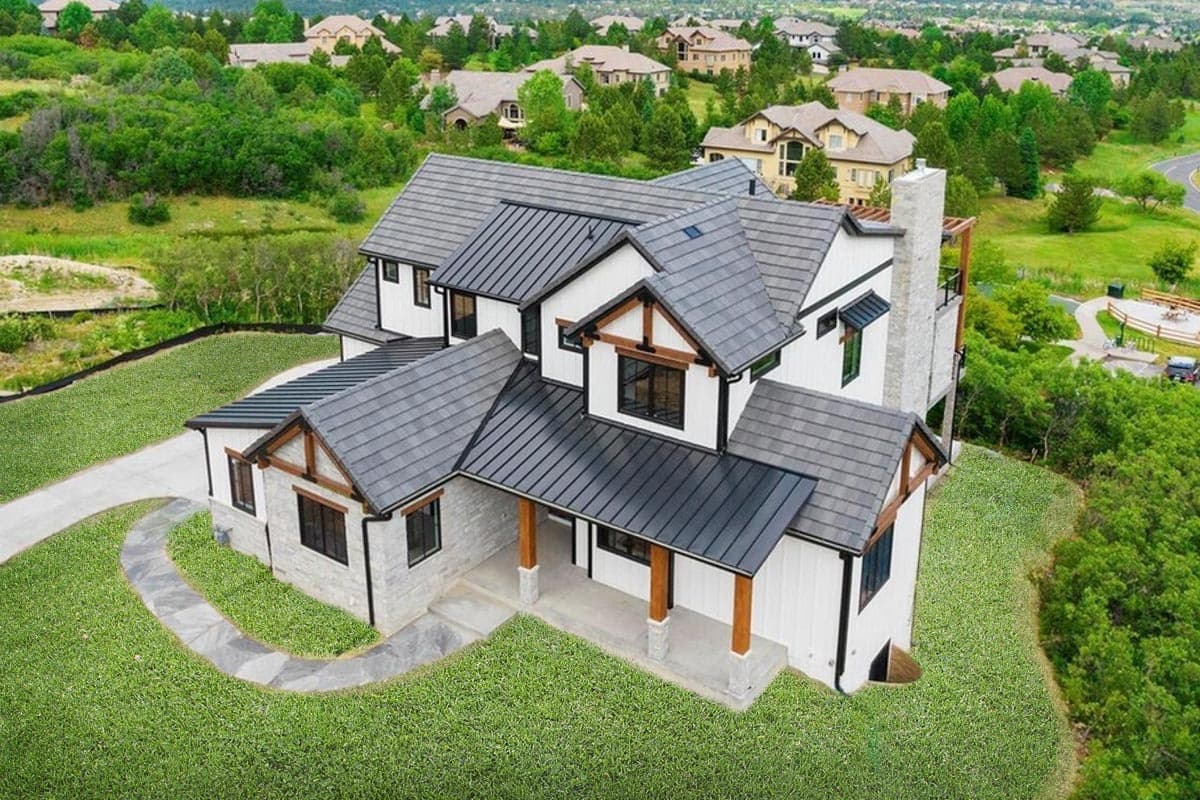 Modern Farmhouse house plan exterior with stone and white siding, metal roof, gables, and covered porch.