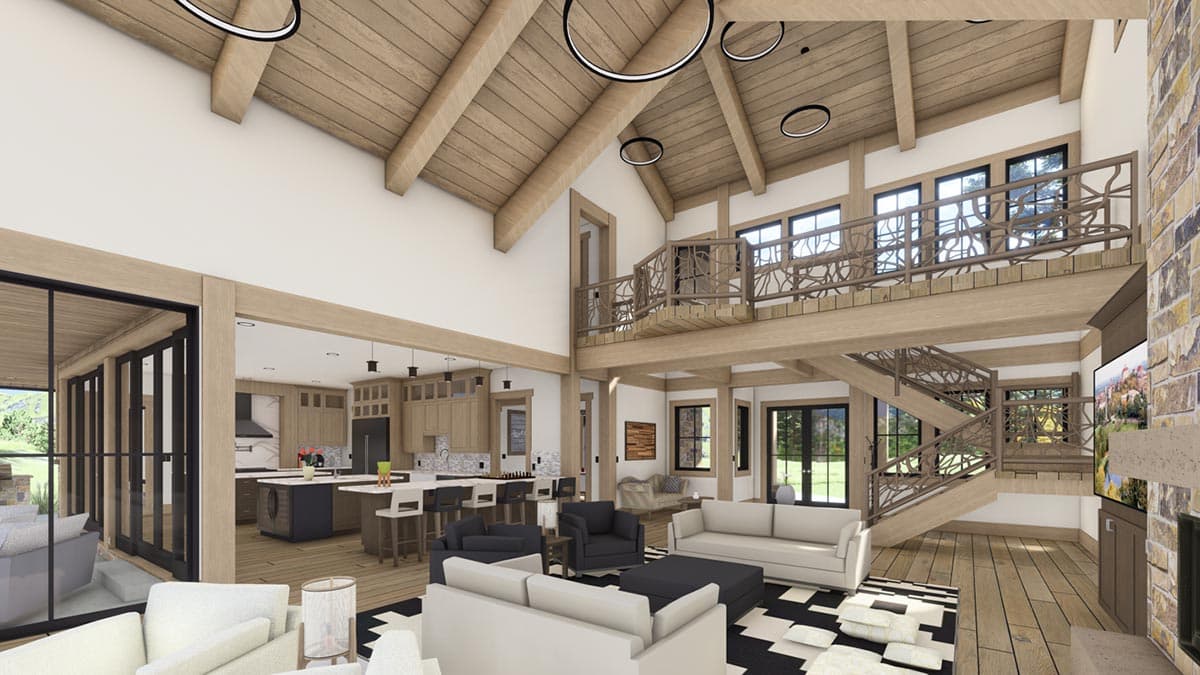 A modern, open-concept living space with exposed wooden beams, a loft, and a kitchen visible in the background. Furnished with sofas and seating.