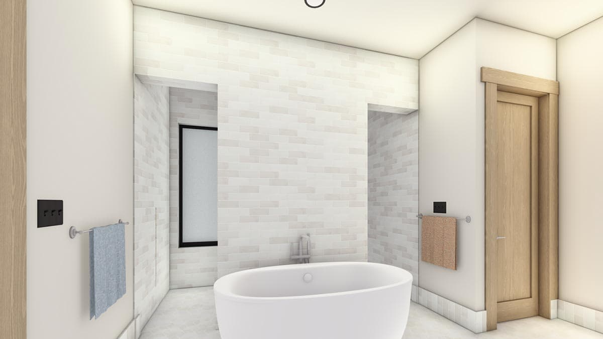 Modern bathroom with a white oval bathtub, brick-like tile walls, and a wooden door. Towels hang on adjacent walls.