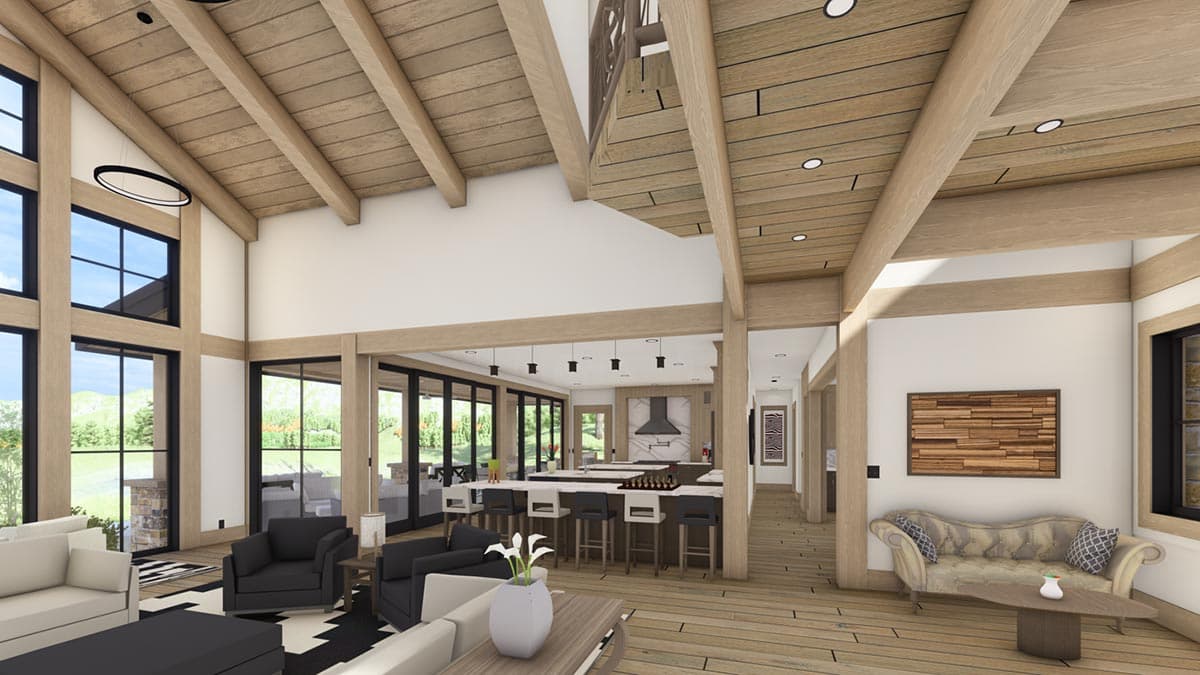 Spacious interior with exposed wooden beams, high ceilings, large windows, and an open kitchen with a central island and bar seating.